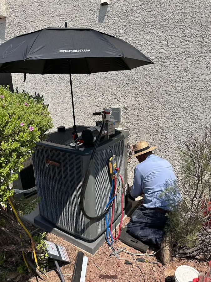 HVAC technician performing outdoor AC maintenance in Lopatcong