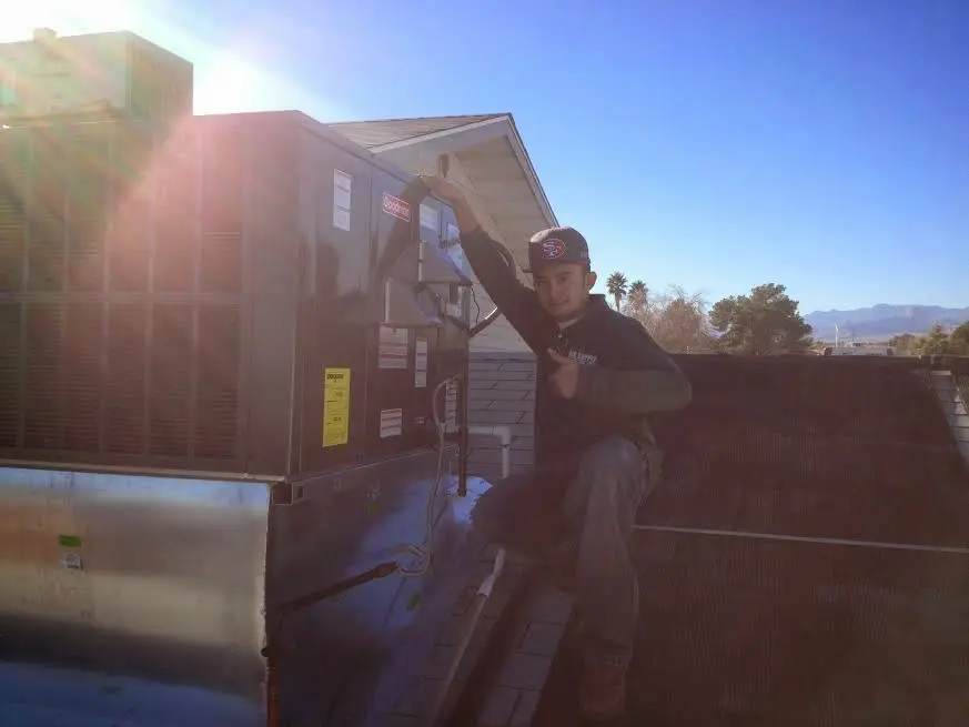HVAC technician performing HVAC Inspection on a rooftop unit in Lopatcong